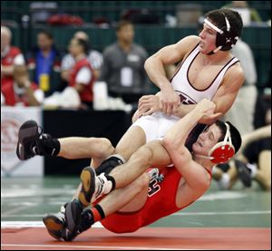 Oak Harbor s Drew Stone takes University School s James Inghram to the mat in the Division II
119-pound state semifi nal. Stone will wrestle for a state championship in Columbus Saturday.