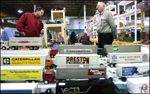 Vendor Don Scheuring of Parma Heights, Ohio, right, stands ready to answer questions from John Quinn of Cleveland at the 95th Toledo Collectors' Toy Fair at the Lucas County Recreation Center. 