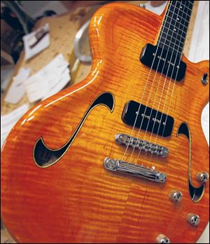 A 419 model semi-hollow electric guitar in Mr. Kopp s shop.