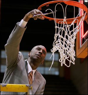 Falcons' coach Louis Orr takes shears to the net after Bowling Green took the regular-season MAC crown with a win over Ohio on Sunday.