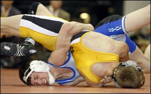 Elmwood's Nick Goebel, left, tries to gain controi of Beachwood's Alex Dronzek in their 103-pound championship match Saturday in Columbus. Goebel won 3-2 to finish his season 47-0. 
<br>
<img src=http://www.toledoblade.com/graphics/icons/photo.gif> <font color=red><b></b></font><a href=