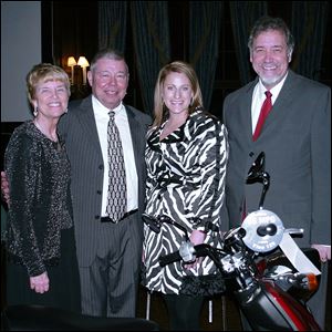 From left, Betsy and Tom Brady,
Carla Firestone, and Marty Porter admire the Yamaha Vino 125 in raspberry metallic. The scooter is worth $3,500.
<br>
<img src=http://www.toledoblade.com/graphics/icons/photo.gif> <font color=red><b>VIEW</b></font>: <a href=