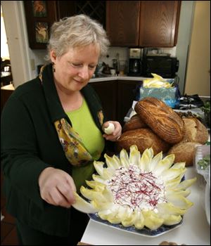 Paula Ross makes a plate of endive with dip for her dinner party for author Marion Nestle and other guests.