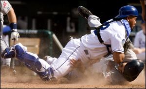 The Indians' Grady Sizemore is tagged out by Royals catcher Miguel Olivo while trying to score from third on a wild pitch in the ninth inning. 