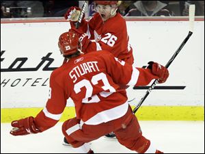 Jiri Hudler and Brad Stuart celebrate Hudler's second-period goal as the Wings won their playoff opener against the Jackets.
