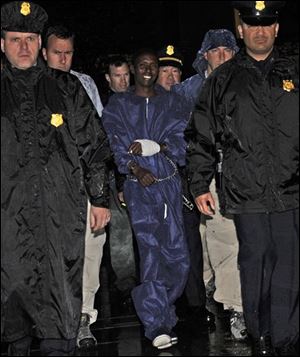 Police and FBI agents escort the Somali pirate suspect U.S. officials identified as Abduhl Wali-i-Musi into FBI headquarters in New York on Monday, April 20, 2009. Abduhl Wal-i-Musi is the sole surviving Somali pirate suspect from the hostage-taking of commercial ship captain Richard Phillips from the Maersk Alabama.