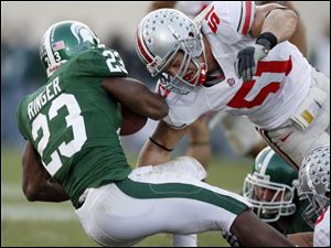 Ohio State defender Ross Homan hits Michigan State running back Javon Ringer (23). Without James Laurinaitis and Marcus Freeman, Homan should play a bigger role for the Buckeyes.