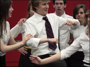 Ryan Schmidt, center, a senior at St. Francis de Sales High School, dances with other members of the cast as they prepare for performances of 'Anything Goes,' the school's spring musical. The cast of 55 includes students from St. Ursula and Notre Dame academies. The show will be presented at the Franciscan Theatre at Lourdes College in Sylvania at 7:30 p.m. May 1, 2, 8, and 9. Ticket prices are $12 for adults, $10 for senior citizens, and $6 for students. They can be ordered by calling the school at 419-531-1618.