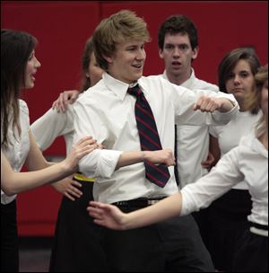Ryan Schmidt, center, a senior at St. Francis de Sales High School, dances with other members of the cast as they prepare for performances of 'Anything Goes,' the school's spring musical. The cast of 55 includes students from St. Ursula and Notre Dame academies. The show will be presented at the Franciscan Theatre at Lourdes College in Sylvania at 7:30 p.m. May 1, 2, 8, and 9. Ticket prices are $12 for adults, $10 for senior citizens, and $6 for students. They can be ordered by calling the school at 419-531-1618.