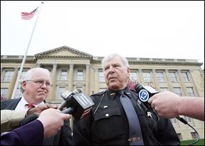 Sheriff James Telb talks to media representatives after his appearance in federal court Friday and expresses confidence that he will be exonerated. His attorney, Rick Kerger, is at left.