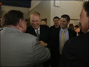 Gov. Ted Strickland and state Rep. Matt Szollosi, right, greet state Rep. Peter Ujvagi, left, back to camera, at Mr. Ujvagi s annual Paprikas Dinner at St. Stephen s School Hall in East Toledo. Last night s event was the latest in a series dating to  1981. The governor was the keynote speaker.
