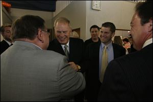 Gov. Ted Strickland and state Rep. Matt Szollosi, right, greet state Rep. Peter Ujvagi, left, back to camera, at Mr. Ujvagi s annual Paprikas Dinner at St. Stephen s School Hall in East Toledo. Last night s event was the latest in a series dating to  1981. The governor was the keynote speaker.