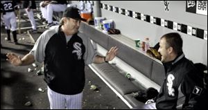 White Sox pitching coach Don Cooper, left, talks with his ace, Mark Buehrle, in the dugout after Buehrle took a perfect baseball game into the seventh inning against the Tigers.