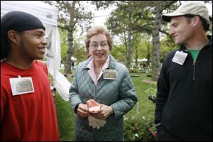 Rep. Marcy Kaptur visits with master gardener Rob McCreary, left, of Toledo and Mike Szuberla of the Toledo Grows nonprofit group during the plant sale at Toledo Botanical Garden. 