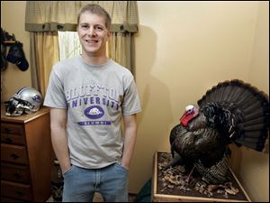 In a T-shirt announcing the status he acquired this year, Tim Berta stands unassisted and proud in his parents' home.