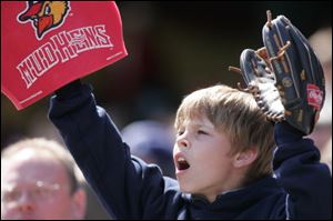 Joel Gyurasics, a third-grader at Toledo Christian, is ready to catch the ball at the Fifth Third Field on Monday. 