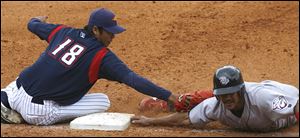 Mud Hens pitcher Fu-Te Ni tags out Lehigh Valley s Jason Ellison at fi rst base in the eighth inning. Ni threw to first for a pickoff, then made the tag in a rundown.