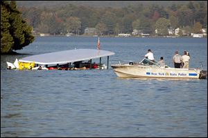 The tour boat Ethan Allen is raised one day after it flipped on Oct. 2, 2005, killing 20 passengers, including five Bedford Township residents and one Toledoan.