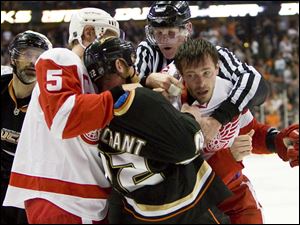 Nicklas Lidstrom (5) and an official try to pull apart the Ducks' Todd Marchant and the Wings' Pavel Datsyuk after Game 6.
