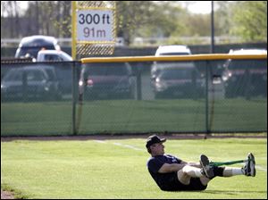 Jim Burnor stretches before his game; he is a self-employed real-estate appraiser.