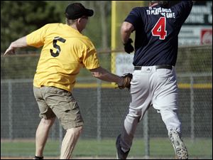 Tom Birie, left, of the Fricker s Yellow Team, tries to tag Greg Phaflar of Allshred.