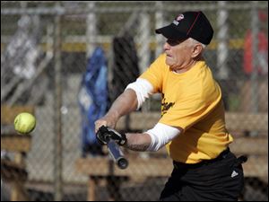 Lee Kramer, 79, hits a single for his Fricker s Yellow Team during a recent game against Allshred Services. The game was one of the first games of the season in Sylvania Softball League play at Pacesetter Park. Mr. Kramer owns Kramer Insurance Services.
