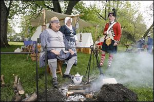 Members of Campeau Company, Detroit Militia, from the Revolutionary War period are, from left, re-enactors Tom and Shirley Lonsdale of Redford, Mich., and David Marquis of Plymouth, Mich., who portrays a member of the 42D Royal Highlanders, a British company in the American Revolution.