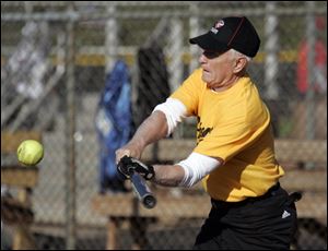 Lee Kramer, 79, hits a single for his Fricker s Yellow Team during a recent game against Allshred Services. The game was one of the first games of the season in Sylvania Softball League play at Pacesetter Park. Mr. Kramer owns Kramer Insurance Services.