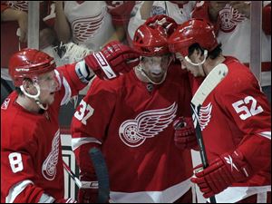 Detroit s Mikael Samuelsson, center, is congratulated by teammates Justin Abdelkander, left, and Jonathan Ericsson after his game-winning shot in overtime.