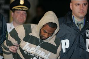 David Williams, aka Daoud, is led by police officers from a federal building in New York early Thursday after being arrested on charges related to a bombing plot in the Bronx. 