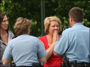 Toledo Police speak to unidentified women at the scene of the shooting.