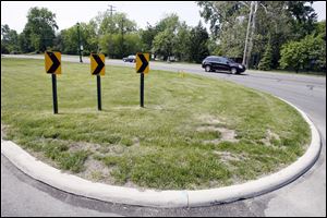 One of two motorcyclists being pursued by Ottawa Hills police drove across this grass island at Central Avenue and Indian Road. As he was being arrested Saturday, his companion was shot.