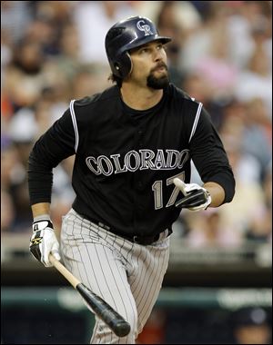 Todd Helton watches his solo home run clear the fence in the sixth inning Saturday night in Detroit as the Rockies won 4-3.