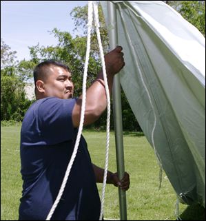 Ben Garcia, of Meredith Party Rentals, prepares a tent for a party. A spokesman said the pace of orders is slower than in years past.  
