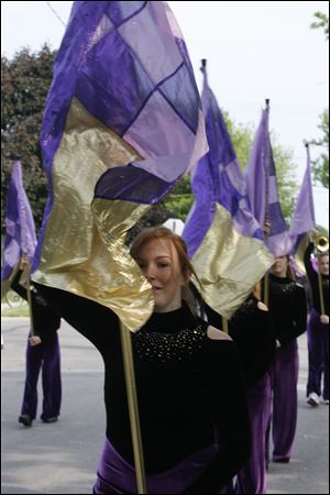 Adrian McKinney of the Maumee High School flag corps marches along the route. Some 45 organizations took part in the parade.