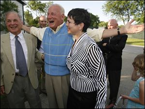 Slug: SOC surprise01p E     The Blade/Jeremy Wadsworth  Date: 05/30/09  Caption: Carty Finkbeiner greets his brother David Finkbeiner as his wife Amy Finkbeiner looks on during his surprise birthday party Saturday, 05/30/09, at the Carranor Hunt and Polo Club in Perrysburg, Ohio.