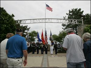 CTY memorial31p         05/30/2009     The Blade/Lori King  The Honor Guard retires the colors during the dedication of the Korean War monument at Clay High School's Memorial Stadium in Oregon, OH.