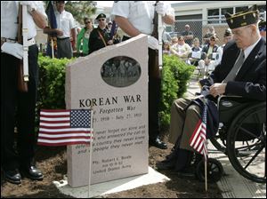 CTY memorial31p         05/30/2009     The Blade/Lori King  Former Oregon mayor Jim Haley, in wheel chair, observes the unveiling of the Korean War monument during its dedication at Clay High School's Memorial Stadium in Oregon, OH.