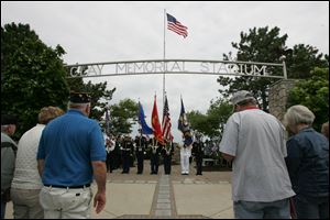 CTY memorial31p         05/30/2009     The Blade/Lori King  The Honor Guard retires the colors during the dedication of the Korean War monument at Clay High School's Memorial Stadium in Oregon, OH.