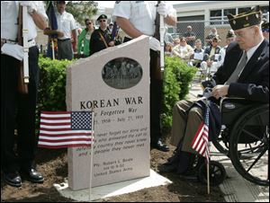 CTY memorial31p         05/30/2009     The Blade/Lori King  Former Oregon mayor Jim Haley, in wheel chair, observes the unveiling of the Korean War monument during its dedication at Clay High School's Memorial Stadium in Oregon, OH.