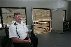 Fire Chief M Dimick shows off the exercise room on the second floor of the new fire station.