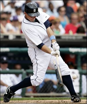 The Tigers' Brandon Inge gets a broken-bat single in the eighth Sunday against the Brewers.