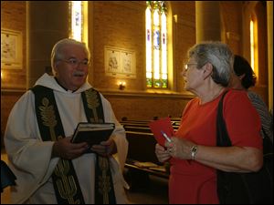 CTY Kwiatkowski29p  40-year parishioner Maria Carmen Fragoso, right, with an autographed copy a musical work [in left hand]by Fr. Paul Kwiatkowski, left. Father Paul Kwiatkowski of Immaculate Conception Parish, Toledo, retires, saying his last Mass in that position on Sunday, June 28, 2009.  The Blade/Jetta Fraser
