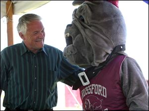 Slug: CTY rossford29p                Date 6/28/2009           The Blade/ Amy E. Voigt              Location: Rossford, Ohio NOTE TO DESK: Randy gardner was the only official at event.  CAPTION:  Brian Hughes, President of the Rossford School Board, left, chats with the Rossford Bulldog Mascot, who is being played by school board member Jackie Brown, right, during the groundbreaking for the first phase of Rossford School District's $14 million athletic complex.