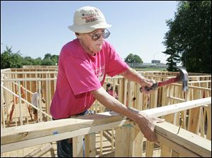 NBRE habitat01p  06/26/09  The Blade/Dave Zapotosky Caption:  Bill Forsee of Christ Presbyterian Church in Toledo hammers nails at a Habitat for Humanity build on Ansonia St. in Oregon, Ohio, Friday, June 26, 2009.  Two homes were being constructed by a large group of volunteers including some from five are religious congregations, the United Way Women's Initiative, and the National Association of Women in Construction (NAWIC), Toledo Chapter.   Summary: Habitat for Humanity build in Oregon.