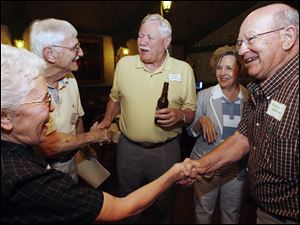 Phyllis Hughes, left, of Houston greets Douglas and Joanna MacPherson of Baton Rouge. Larry Hughes greets class president George Ackerman, center at Clay High s 60th reunion at Oak Shade Grove.