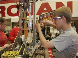 NBRN robot01p  The Blade/Lisa Dutton 06_27_09 Monroe,MI Chris Sommers,soph from team Bedford Express works on the advanced robot during the competition. An advanced robotics team competition will be held at Monroe High School in Monroe,MI.,  on friday and Saturday. High school teams from as far away as Wisconsin and Indianapolis will attend.