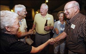 Phyllis Hughes, left, of Houston greets Douglas and Joanna MacPherson of Baton Rouge. Larry Hughes greets class president George Ackerman, center at Clay High s 60th reunion at Oak Shade Grove.