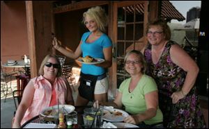 Terry Helbing, waitress Alyssa Morelock, Karen Johansen and Rosanne Babiuch, on the patio at Tangos Mexican Cantina patio in Toledo. They are life-long friends who meet about once a month for dinner.