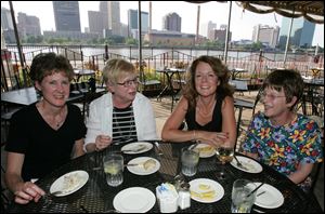 Enjoying a meal on the Real Seafood s patio were, from left, Nancy Newbury, Ginny Salander, Jennifer Dubow, and Eileen Burg.